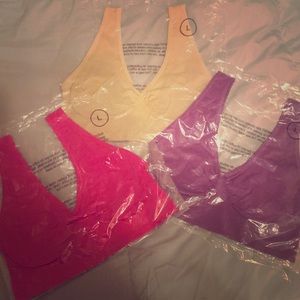 Three large bras (pink,purple, and tan)